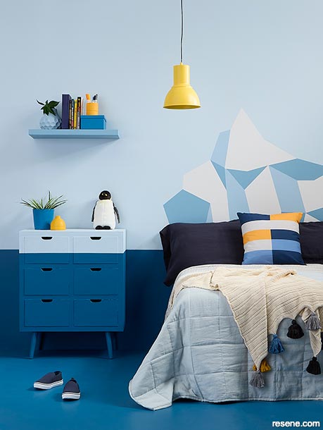 A kids' bedroom with an iceberg mural