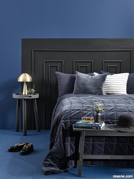 A bedroom with a dark and dramatic colour scheme