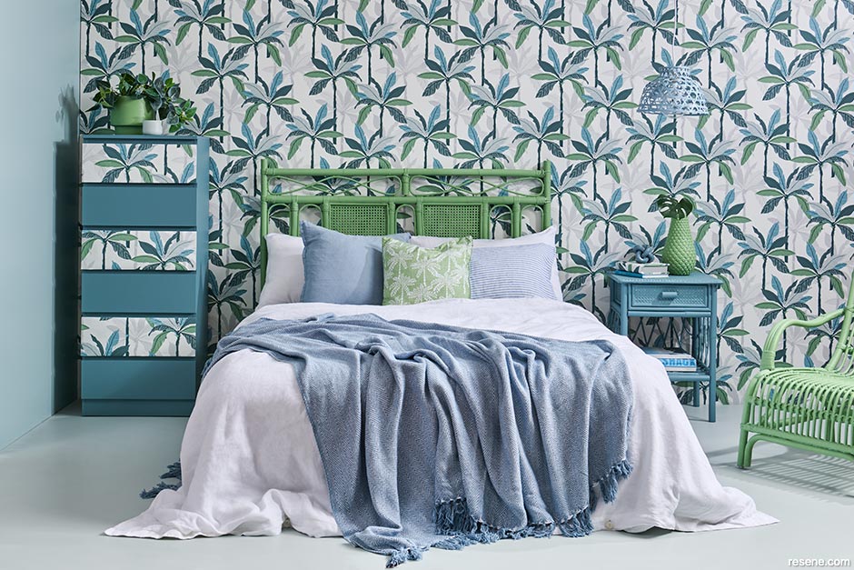 A wallpapered tropical themed bedroom