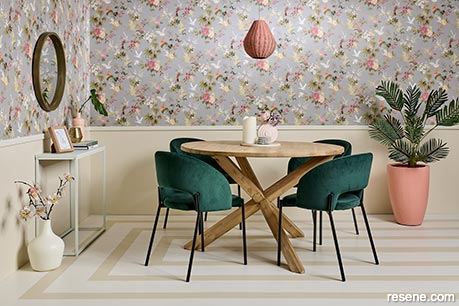 A dining room with floral wallpaper