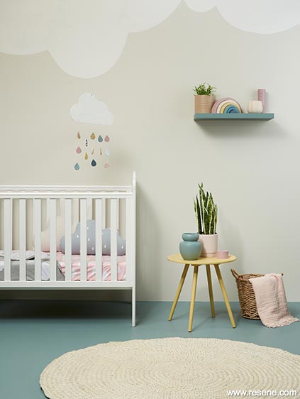 A cute nusery in calming green and cream