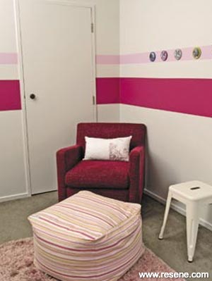 A white nursery with pink stripes