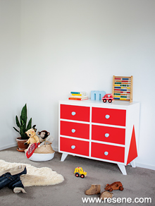 Paint a chest of drawers with a bold colour