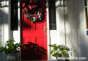 The chosen colours change the feel of this villa - Resene Red Berry door