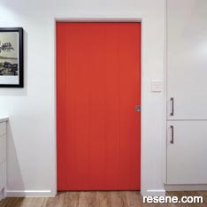 A an orange door in Resene Daredevil