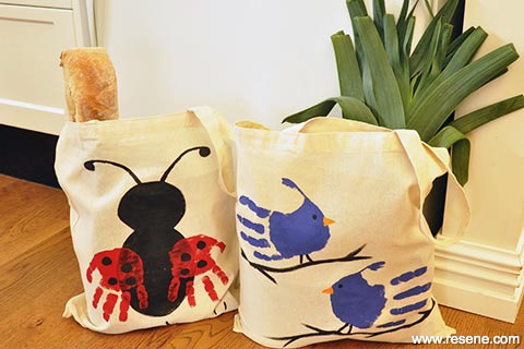 Handprint bugs and birds onto calico bags