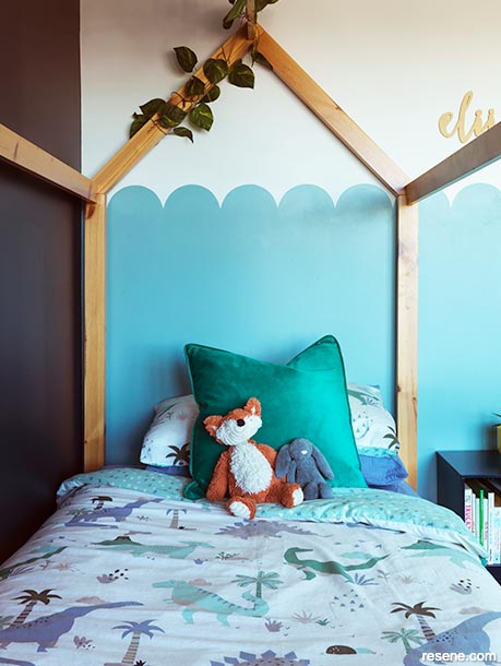A kids bedroom with a wave design on the wall