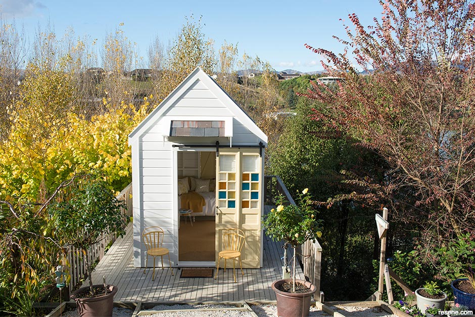 A summerhouse exterior with colourful shutter details