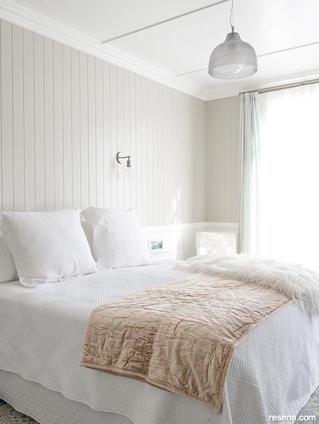 A villa bedroom in fresh neutrals