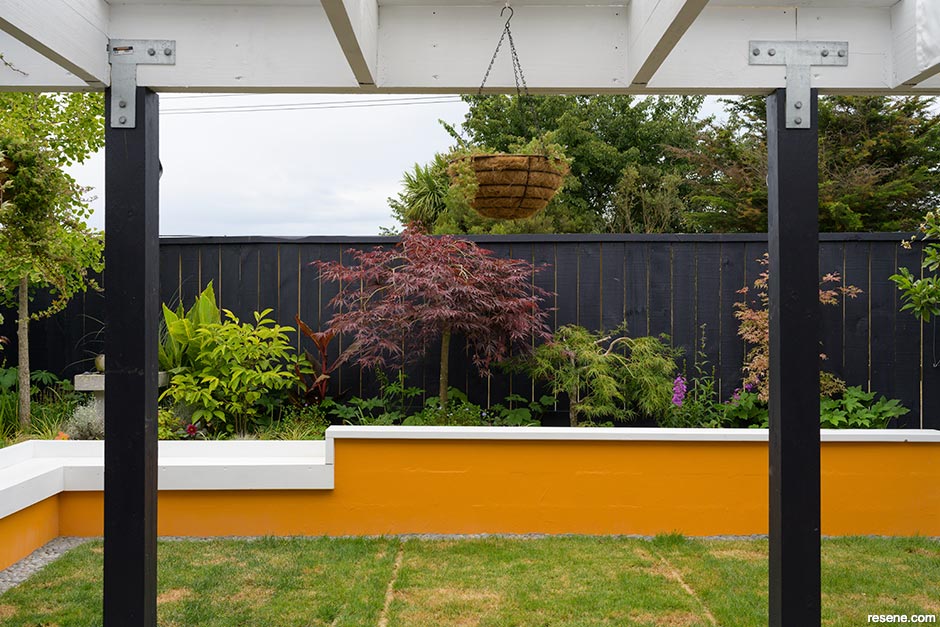 A raised garden bed painted orange and white