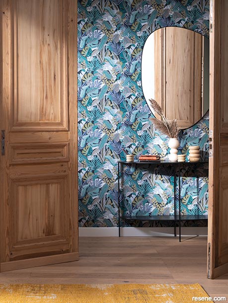 A powder room with busy blue wallpaper