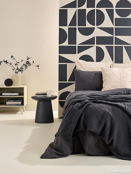 A bold, geometric feature wall features in this bedroom