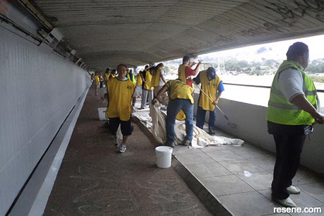 Volunteers freshen up the paintwork in Māngere