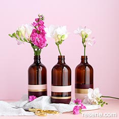 Upcycle glass bottles to painted vases