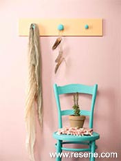 Turn an old drawer front into a coat rack then paint it in soft desert sunset tones.