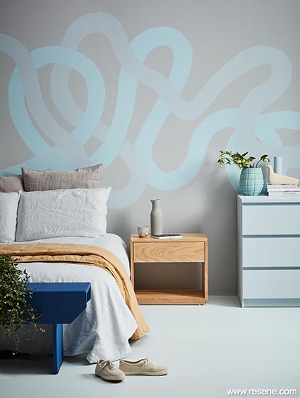 Calm, peaceful bedroom inspired by the sea, painted swirly headboard