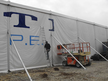 Signwriting a large PVC expo marquee's wall