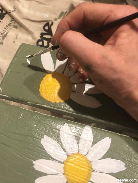 Painting daisies on a picnic table