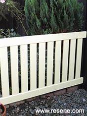 Make a smart wooden fence from a bedhead.